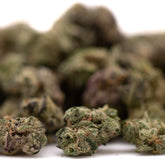Pile of dried cannabis buds from Astroboy Indoor THCa Flower Smalls with small buds